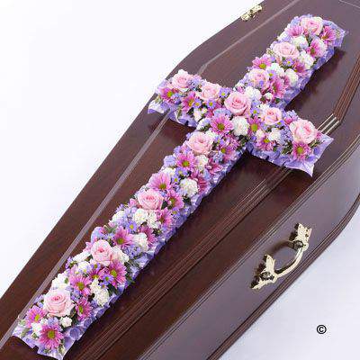 <h2>Large Pink and Lilac Classic Cross-Shaped Design | Funeral Flowers</h2>
<br>
<ul>
<li>Approximate Size W 45cm H 130cm</li>
<li>Hand created large pink and lilac classic cross in fresh flowers</li>
<li>To give you the best we may occasionally need to make substitutes</li>
<li>Funeral Flowers will be delivered at least 2 hours before the funeral</li>
<li>For delivery area coverage see below</li>
</ul>
<br>
<h2>Liverpool Flower Delivery</h2>
<br>
<p>We have a wide selection of Funeral Crosses offered for Liverpool Flower Delivery. Funeral Crosses can be provided for you in Liverpool, Merseyside and we can organize Funeral flower deliveries for you nationwide. Funeral Flowers can be delivered to the Funeral directors or a house address. They can not be delivered to the crematorium or the church.</p>
<br>
<h2>Flower Delivery Coverage</h2>
<br>
<p>Our shop delivers funeral flowers to the following Liverpool postcodes L1 L2 L3 L4 L5 L6 L7 L8 L11 L12 L13 L14 L15 L16 L17 L18 L19 L24 L25 L26 L27 L36 L70 If your order is for an area outside of these we can organise delivery for you through our network of florists. We will ask them to make as close as possible to the image but because of the difference in stock and sundry items it may not be exact.</p>
<br>
<h2>Liverpool Funeral Flowers | Crosses</h2>
<br>
<p>This large classic funeral cross has been loving handcrafted by our expert florists and features a mix of spray chrysanthemums, roses, spray carnations in pinks and lilacs with luscious green foliage to complete this traditional design.</p>
<br>
<p>Funeral crosses are symbols of belief they reaffirm faith and provide comfort at this difficult time.</p>
<br>
<p>In the larger sizes (from 4ft up) they are appropriate as the main tribute but smaller sizes are sometimes chosen by close friends as they represent extremely personal sentiments and feelings.</p>
<br>
<p>Containing 5 pink spray chrysanthemums, 4 lilac september flower, 12 pink short-stem roses, 15 white spray carnations, 6 lilac statice and seasonal mixed foliage.</p>
<br>
<h2>Best Florist in Liverpool</h2>
<p>Trust Award-winning Liverpool Florist, Booker Flowers and Gifts, to deliver funeral flowers fitting for the occasion delivered in Liverpool, Merseyside and beyond. Our funeral flowers are handcrafted by our team of professional fully qualified who not only lovingly hand make our designs but hand-deliver them, ensuring all our customers are delighted with their flowers. Booker Flowers and Gifts your local Liverpool Flower shop.</p>
<br>
<p><em>Janice Crane - 5 Star Review on Google - Funeral Florist Liverpool</em></p>
<br>
<p><em>I recently had to order a floral tribute for my sister in laws funeral and the Booker Flowers team created a beautifully stunning arrangement. Thank you all so much, Janice Crane.</em></p>
